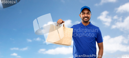 Image of happy indian delivery man with food in paper bag