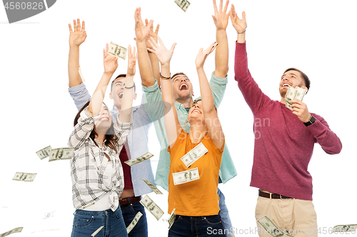 Image of happy friends picking money falling from up above