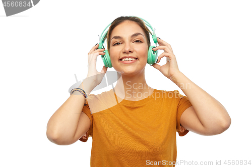 Image of happy young woman or teenage girl with headphones