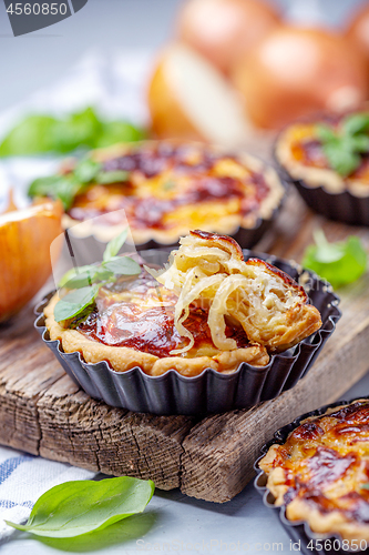 Image of Homemade mini pies with onions.