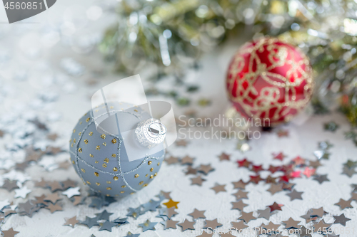 Image of Silver Christmas ball with gold ornament.