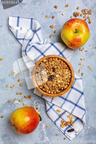 Image of Granola with apple and raisins for breakfast.