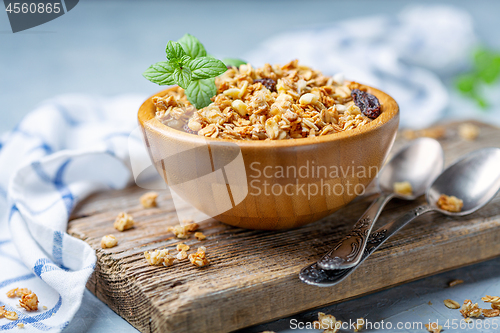 Image of Granola with baked apple in a wooden bowl.