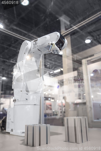 Image of Automatic robot arm working in industrial environment