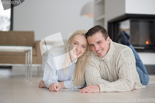 Image of Young Couple using digital tablet on cold winter day