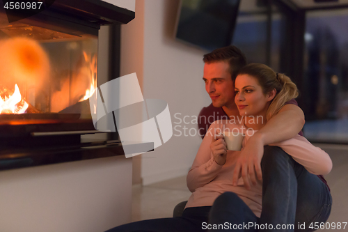 Image of happy couple in front of fireplace