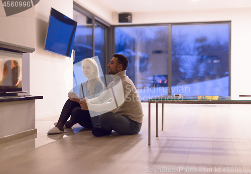 Image of happy couple in front of fireplace