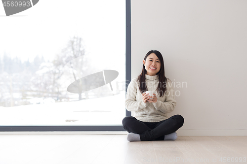 Image of asian woman enjoying morning coffee
