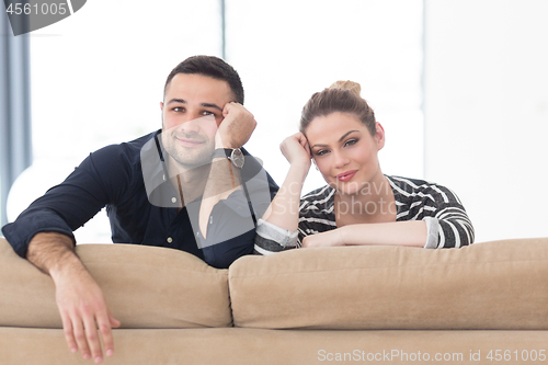 Image of Portrait of young couple sitting on sofa