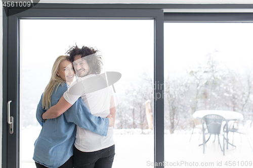 Image of young couple enjoying morning coffee by the window