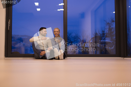 Image of happy couple in front of fireplace