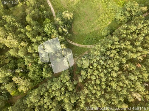 Image of Top view of the winding road through the woods on a summer afternoon. Aerospace with a drone as a natural layout