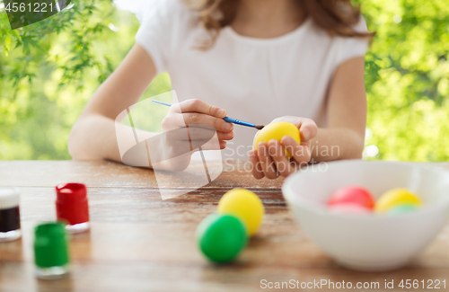 Image of close up of girl coloring easter eggs