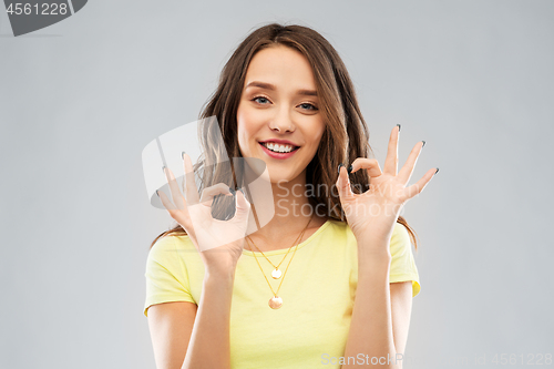 Image of young woman or teenage girl ok hand sign