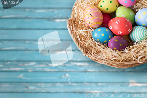 Image of close up of colored easter eggs in basket