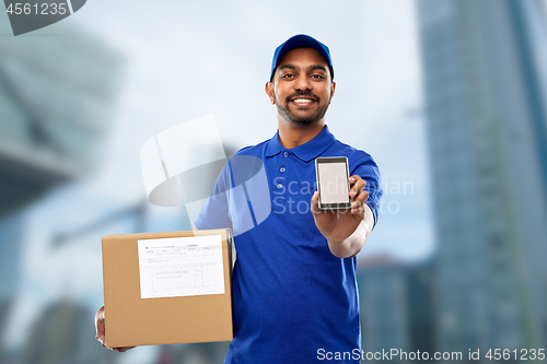 Image of indian delivery man with smartphone and parcel box