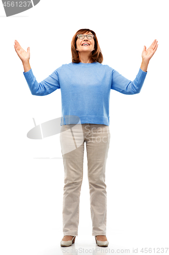 Image of happy senior woman looking up