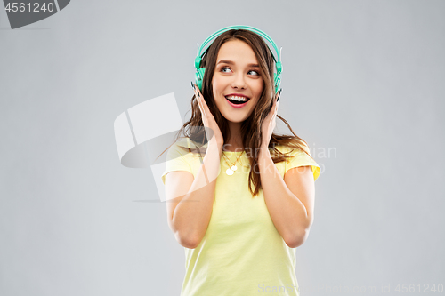 Image of happy young woman or teenage girl with headphones