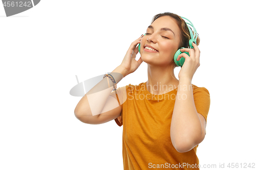 Image of happy young woman or teenage girl with headphones