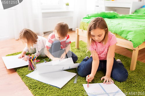 Image of children drawing and making crafts at home