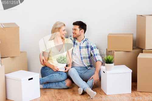 Image of happy couple with boxes moving to new home