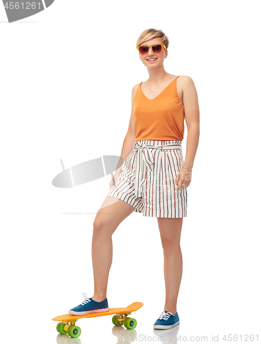 Image of smiling teenage girl with skateboard over white