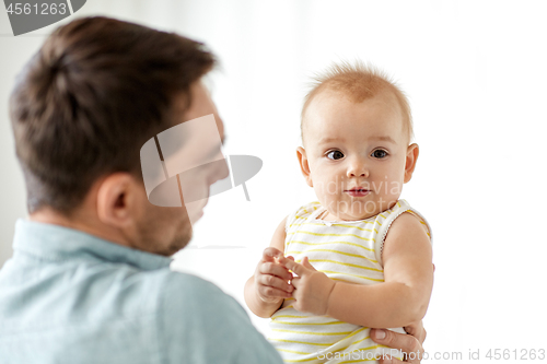 Image of father with little baby daughter on white