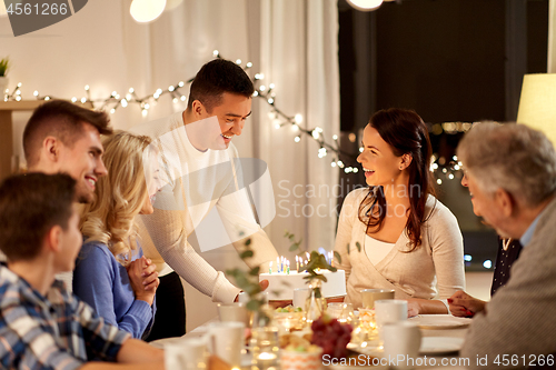 Image of happy family having birthday party at home