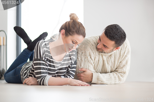 Image of Young Couple using digital tablet on cold winter day