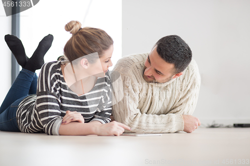 Image of Young Couple using digital tablet on cold winter day