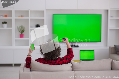 Image of young man in bathrobe enjoying free time