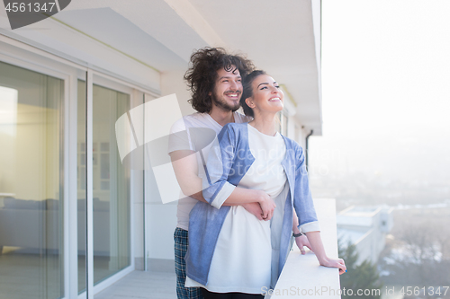 Image of Couple hugging on the balcony