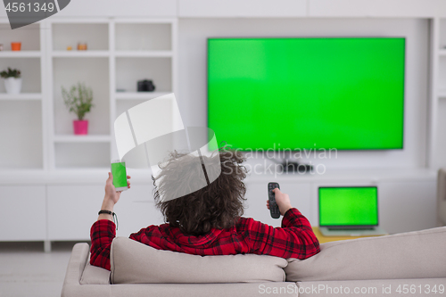 Image of young man in bathrobe enjoying free time