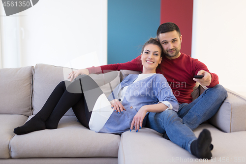 Image of Young couple on the sofa watching television