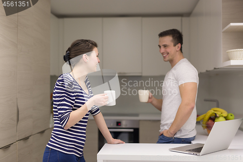 Image of couple with laptop computer enjoying morning