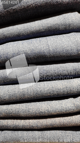 Image of Close up of stack of blue jeans