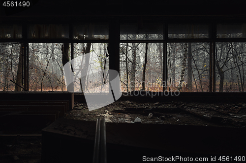 Image of Abandoned building interior with autumnal forest outside