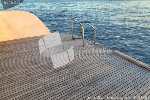 Image of Wet boat deck against blue ocean