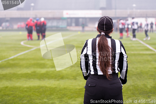 Image of rear view of female american football referee