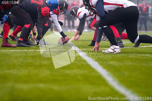 Image of professional american football players ready to start