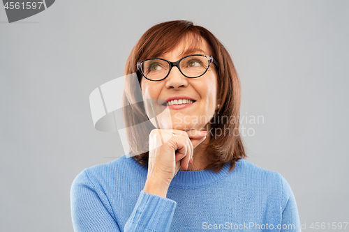 Image of portrait of senior woman in glasses dreaming