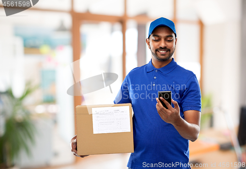 Image of indian delivery man with smartphone and parcel box