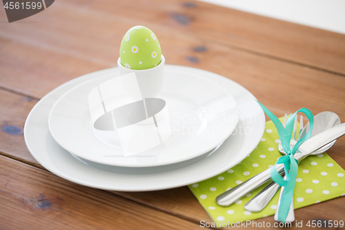 Image of easter egg in cup holder, plates and cutlery