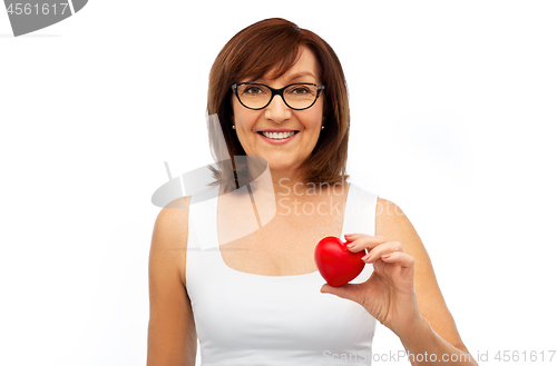 Image of portrait of smiling senior woman holding red heart