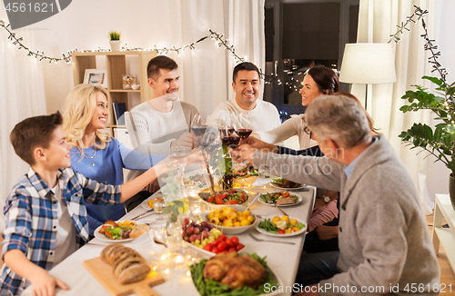 Image of happy family having dinner party at home