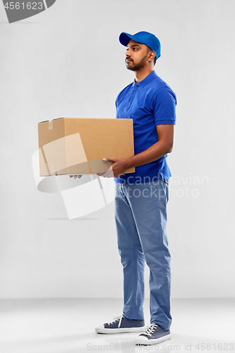 Image of indian delivery man with parcel box in blue