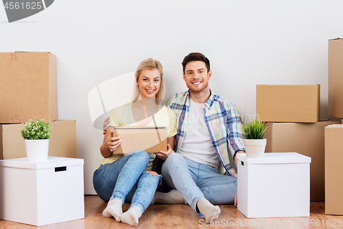 Image of happy couple with boxes moving to new home