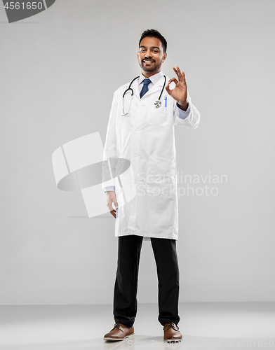 Image of smiling indian male doctor showing ok gesture