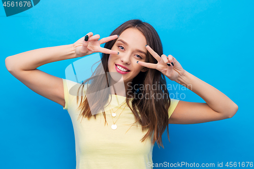 Image of young woman or teenage girl showing peace sign
