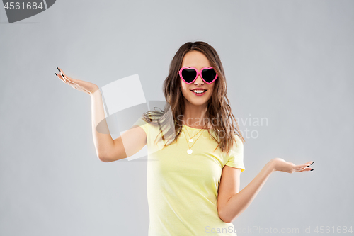 Image of teenage girl in heart-shaped sunglasses